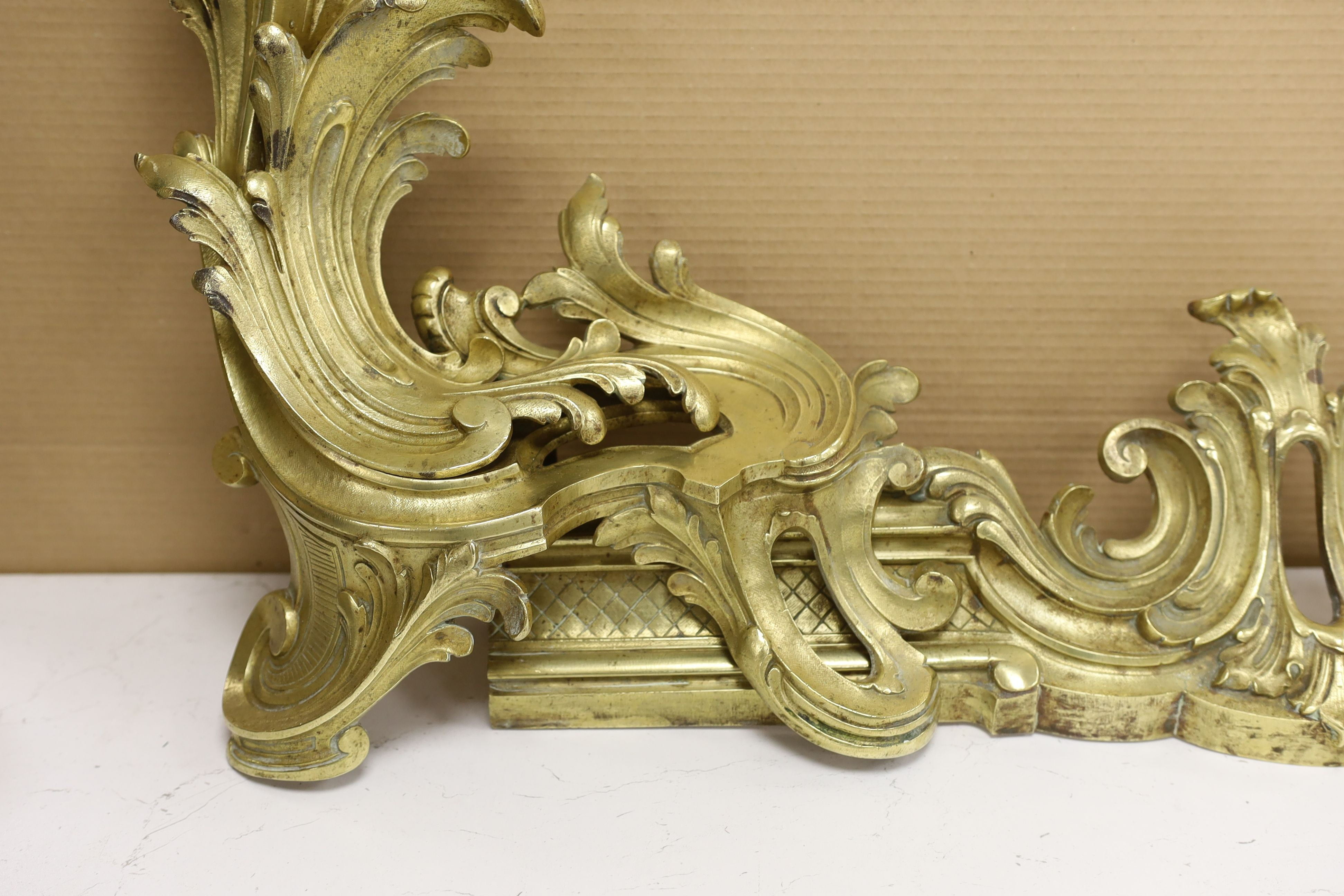 A French rococo style bronze adjustable chenet